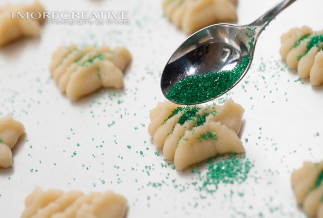 Sprinkling Sugar on Butter Spritz Christmas Cookies